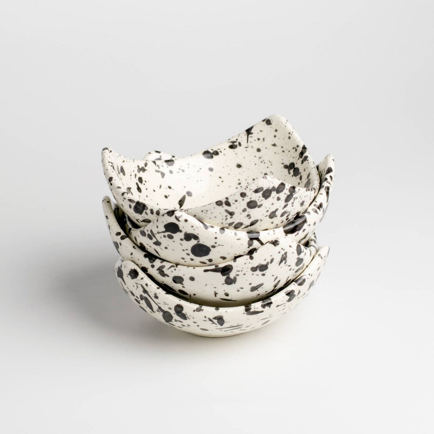 Ceramic triangular bowls with black and white splatter pattern