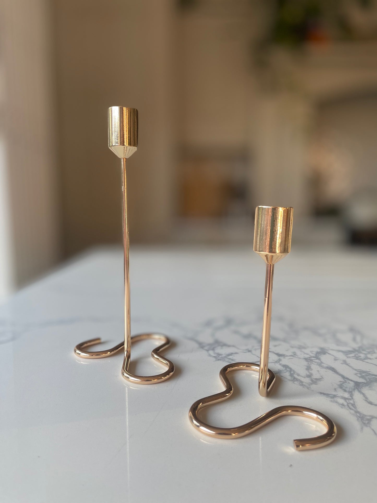 Gold candle holder with squiggly base