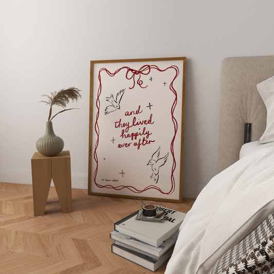 Print with wavy decorative border with a bow and two handdrawn birds with the words 'and they lived happily ever after'.  