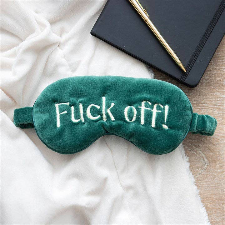 Green velvet eye mask embroidered with the words f*ck off! 